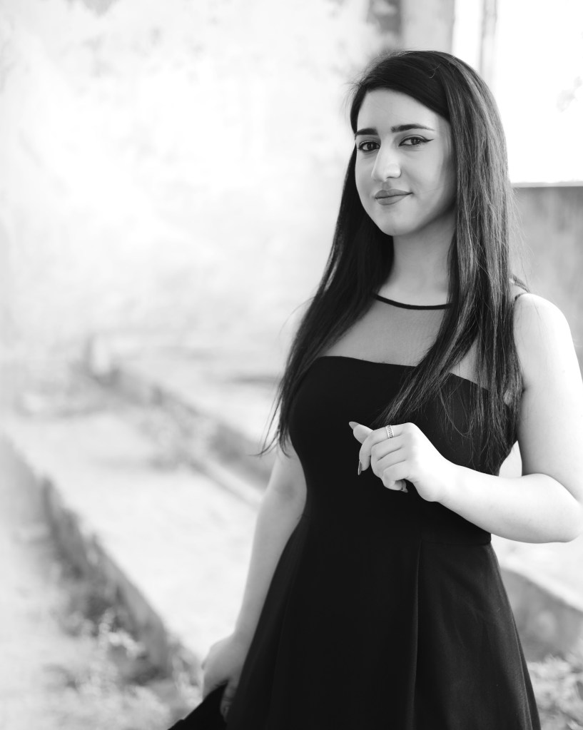 A Black and White image of me, Sarah, in a dress, in an abandoned building.